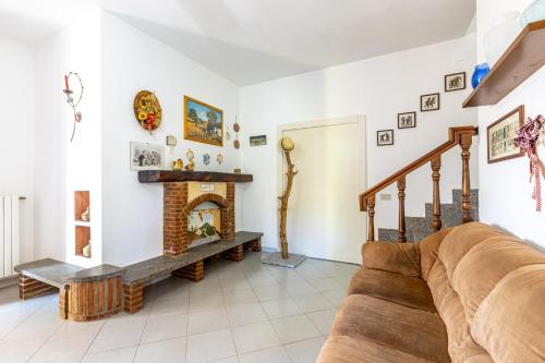 a living room with a couch and a fireplace at Sole Verde green house in Terricciola