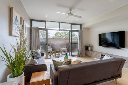 a living room with a couch and a tv at Dunn Bay Apartment 5 - Dunsborough in Dunsborough
