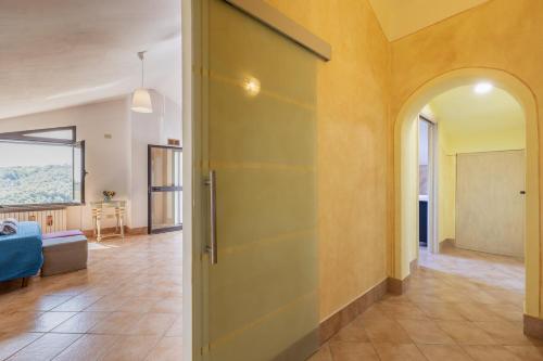 a hallway with a door and a living room at Sole Verde green house in Terricciola