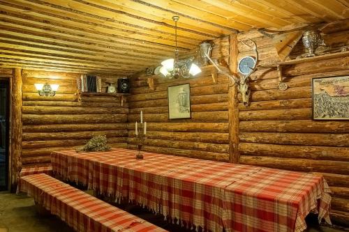 a room with a table in a log cabin at Royal Spa Hotel in Velingrad