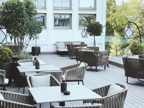 a patio with tables and chairs in a building at Metropol Palace, Belgrade in Belgrade