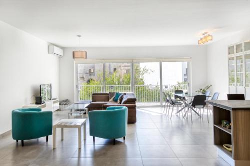 a living room with a couch and a table at Annitchka Mansions - Apartment in central Malta in Birkirkara
