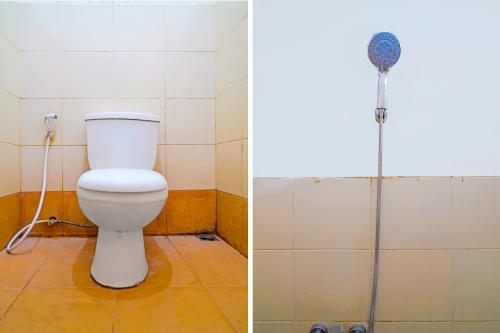 a bathroom with a toilet and a shower at OYO Life 92835 Maya Adipuri in Bandung
