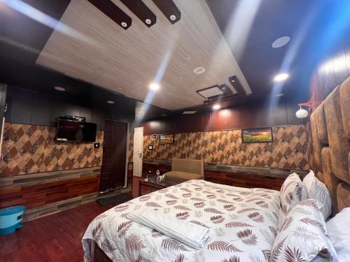 a bedroom with a bed and a tv in it at Pine View Resort in Gulmarg
