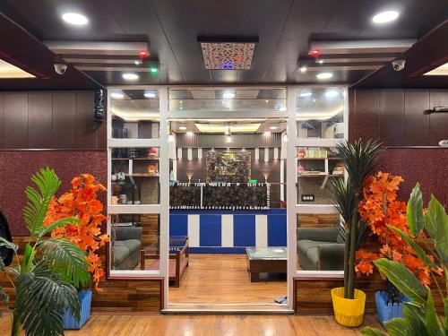 a room with a bar with plants in it at Pine View Resort in Gulmarg