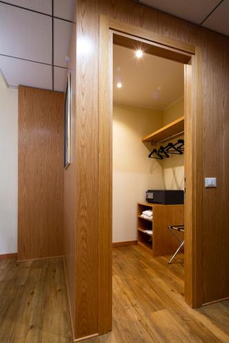 a room with a closet with a wooden door at Crowne Plaza Padova by IHG in Padova