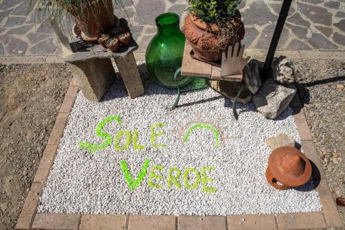 a sign that says save a vase on a rug at Sole Verde green house in Terricciola