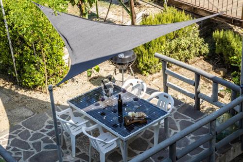 a table and chairs on a balcony with a net at Sole Verde green house in Terricciola
