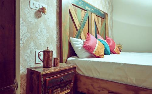 a bedroom with a bed with pillows on it at White Serenity Villa Udupi in Udupi
