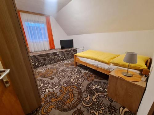 a bedroom with a bed and a lamp on a table at Uriges Landgasthaus in Modriach in Modriach