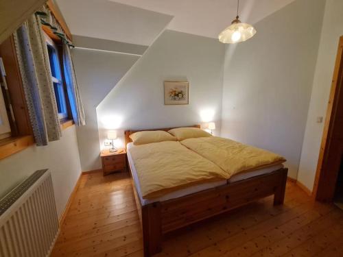 a bedroom with a bed with two lights on it at Uriges Landgasthaus in Modriach in Modriach