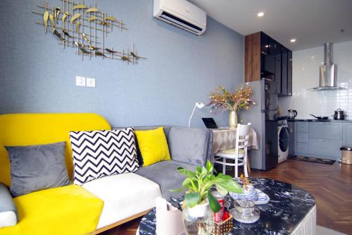 Il comprend un salon avec un canapé et une cuisine. dans l'établissement QMP - Vinhomes Ocean Park, à Hanoï