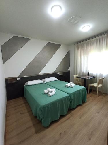 Una cama o camas en una habitación de Affittacamere Ai Pila