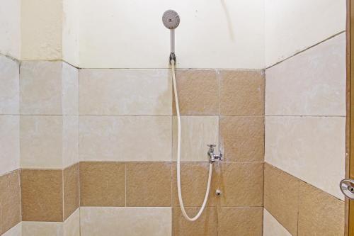 a shower with a shower head in a bathroom at OYO Life 92663 Karmel 6 in Purwokerto