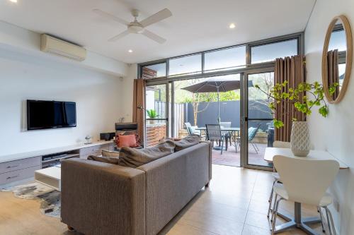a living room with a couch and a tv and a table at Dunn Bay Apartment 3 - Dunsborough in Dunsborough