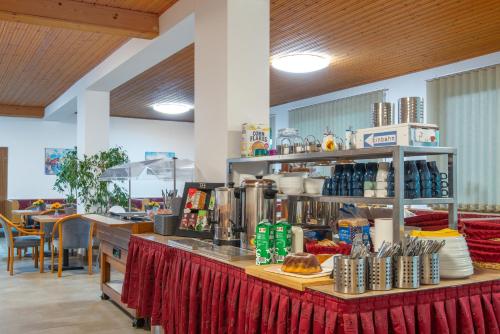 a restaurant with a counter with food on it at Bed & Breakfast Eckwirt in Sankt Kanzian