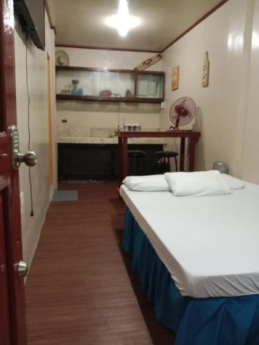 a room with two beds and a desk at TerisitaPlace - DriveBy RestStop in Taytay