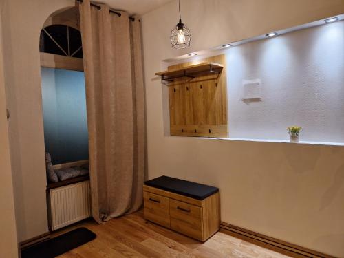 a room with a closet and a cabinet and a table at Maestria Apartament 1 in Sulechów