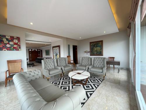 a living room with couches and a table at Lavender - Taman Tanda in Bedugul