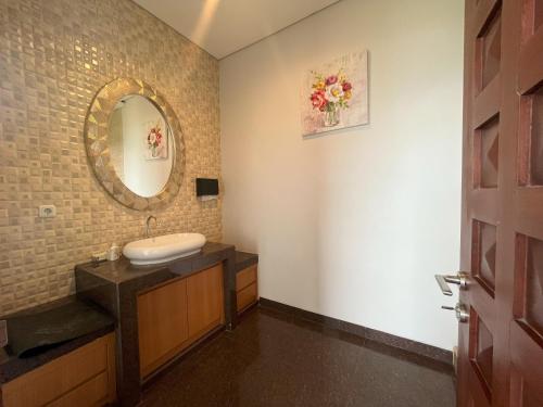 a bathroom with a sink and a mirror at Lavender - Taman Tanda in Bedugul