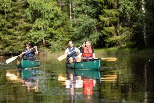 a group of people in kayaks on the water at Sandy Kelt - Irish House Apartments in Kalajoki