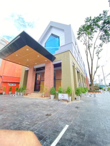 a building with a sign in front of it at Manomon residence มโนมน เรสซิเดนซ์ in Khon Kaen