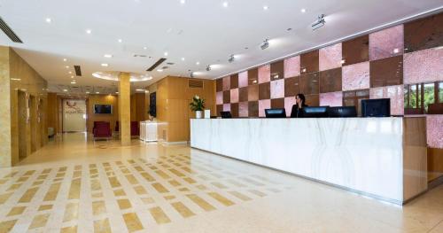 a lobby with a reception desk in a building at Crowne Plaza Padova, an IHG Hotel in Padova