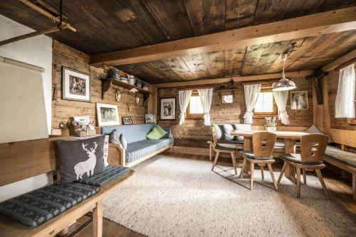 a living room with a couch and a table at Alpenzauber / Chalet AlmZeit / Almhütte Zillertal in Schwaz