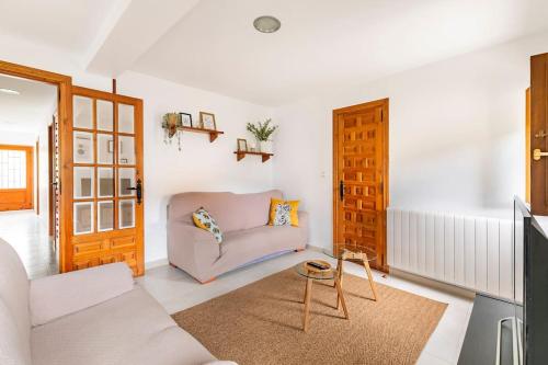 a living room with a couch and a table at Casa Luis - APARTAMENTO con JARDÍN PRIVADO en los PIRINEOS in Castiello de Jaca