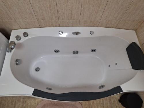 a white bath tub sitting on top of a floor at Apartament Casa Dia 1 in Sibiu