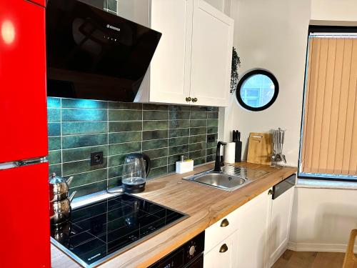 a kitchen with a sink and a stove at HOFT Cihangir in Istanbul