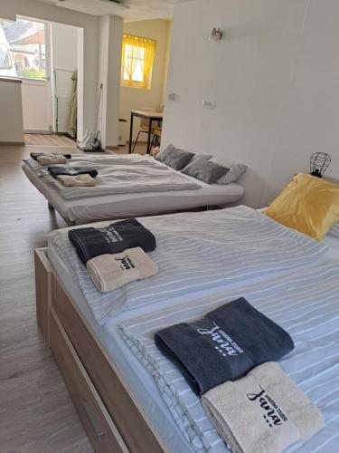 two beds in a room with towels on them at Apartma Studio Jana in Kranjska Gora