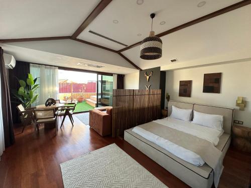 a bedroom with a bed and a living room at HOFT Cihangir in Istanbul