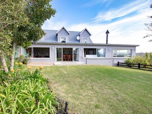 a house with a large yard in front of it at Manhattan Estates - Plettenberg Bay in Plettenberg Bay