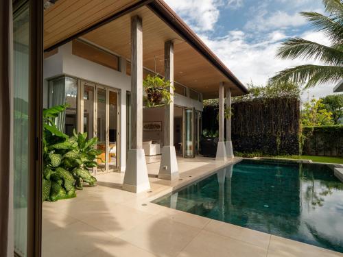 an external view of a house with a swimming pool at Exclusive Villa Botanica in Bang Tao Beach