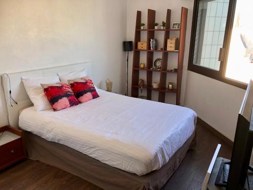 a bedroom with a bed with two pillows on it at Nid de rêve, vue imprenable sur Paris et terrasse 10m2 in Paris