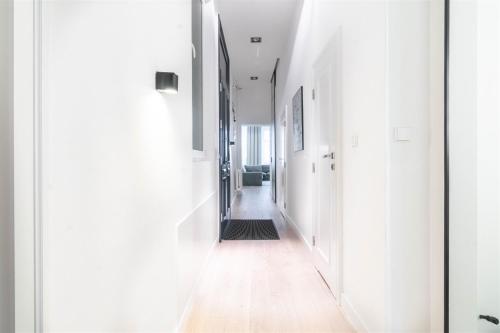 an empty hallway with white walls and wood floors at Spacious Apart in the Center- Main Square 300m in Wrocław