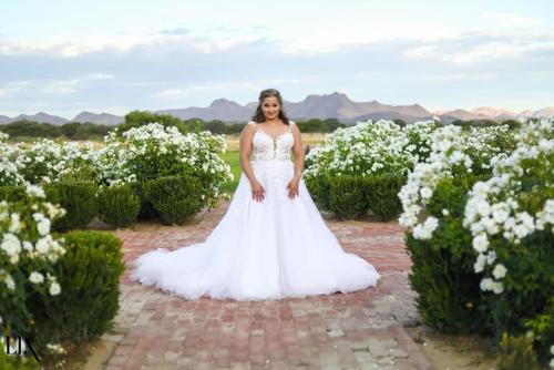 a woman in a wedding dress standing in a field of flowers at Out Of Nature Country Lodge in Windhoek