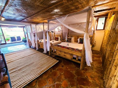 a bedroom with a bed with a canopy at Wag Hill Lodge & Spa in Mwanza