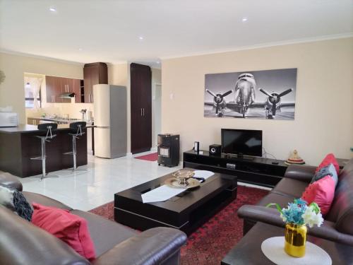 a living room with a couch and a table at Cosy Home In Bluewater Bay in Amsterdamhoek