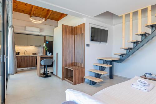 a room with a bed and a staircase and a kitchen at CITY HILL Luxury Apartments in Ioannina