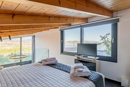a bedroom with a bed and a large window at CITY HILL Luxury Apartments in Ioannina
