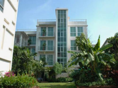 a tall building with a lot of windows and plants at P.K. Garden Home in Bangkok