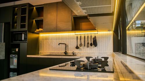 Il comprend une cuisine équipée d'une cuisinière et d'un évier. dans l'établissement MALLO VILLA - DAGO VILLAGE - NEW VILLA & FURNISH, à Bandung