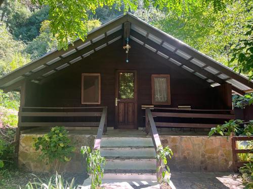 a wooden cabin with stairs leading to a door at Blue Eye Villas in Sarandë