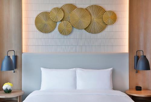a bedroom with a bed with three umbrellas on the wall at DoubleTree by Hilton Dubai - Business Bay in Dubai