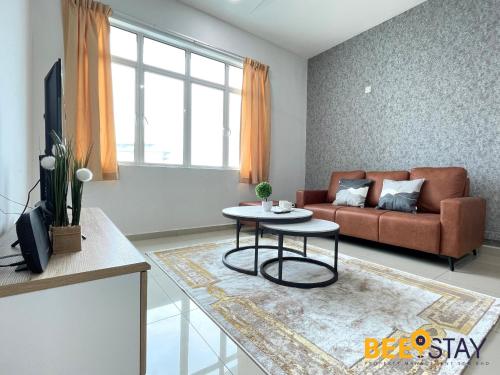 a living room with a couch and a table at KLIA Ehsan Residences Sepang Nilai in Sepang