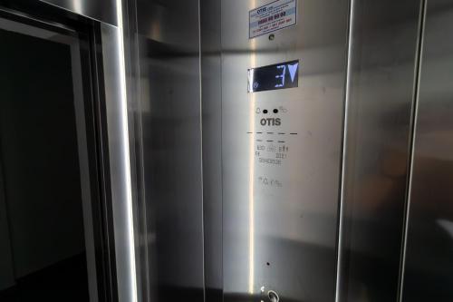 a metal elevator with a sign on the side of it at Gajeva Rooms - Stockholm apartment SELF CHECK-IN in Virovitica