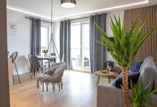 a living room with a couch and a table at Luxus Apartament Bella in Gdynia