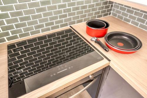 a kitchen counter with a stove and a pan on it at Le Coursannais in Coursan